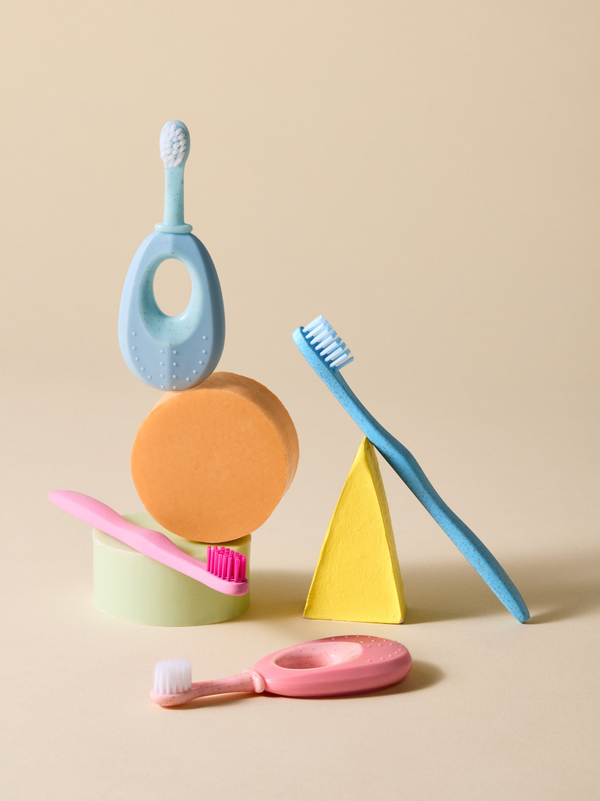 Kids toothbrushes with an beige background