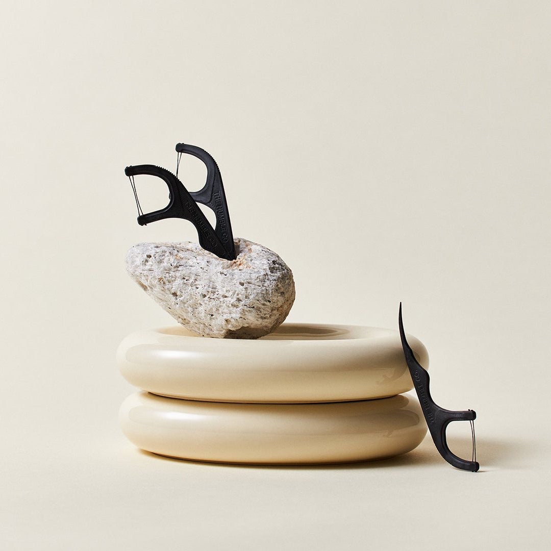 Flosspicks displayed together in with an beige bakground