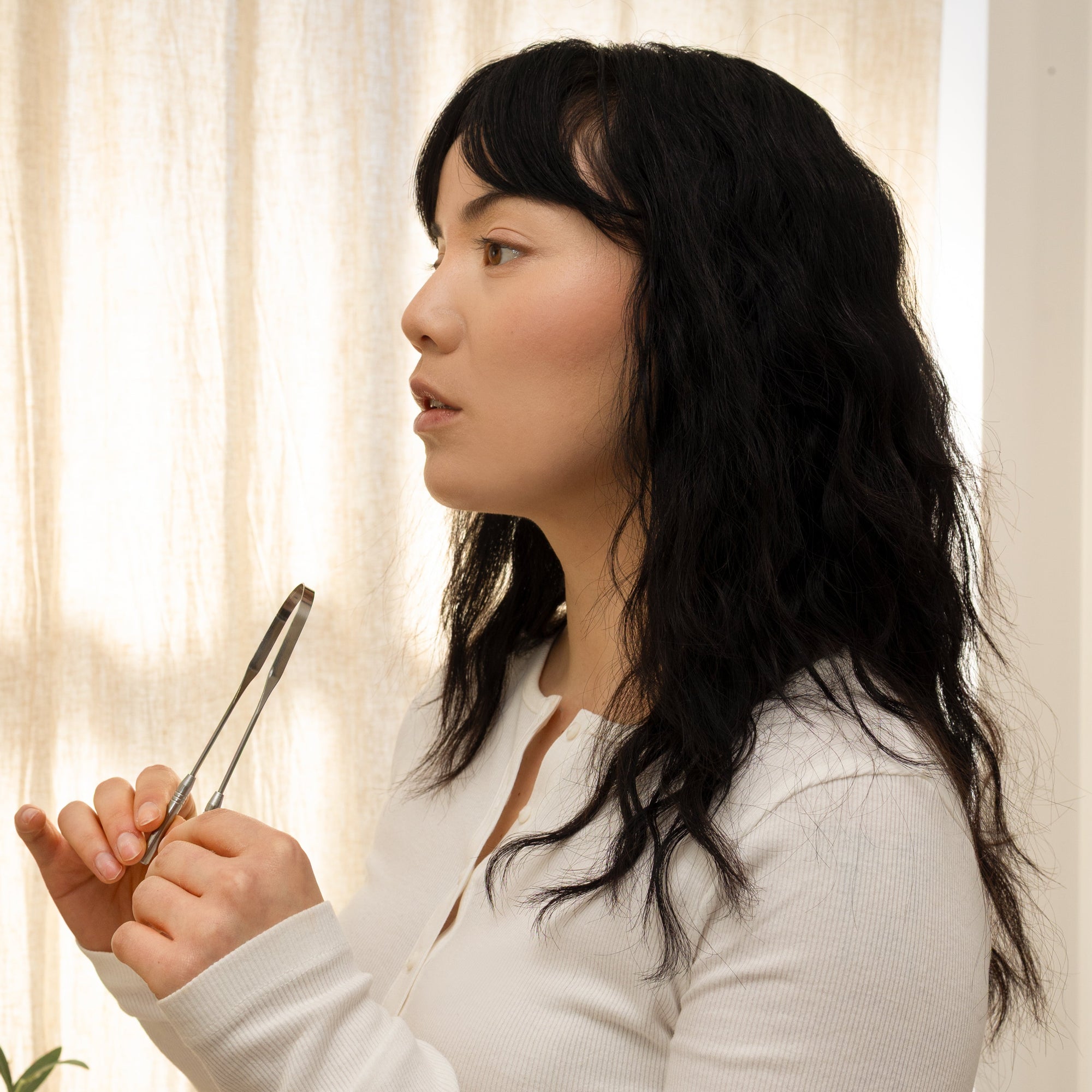 Woman holding a pen in front of a light curtain