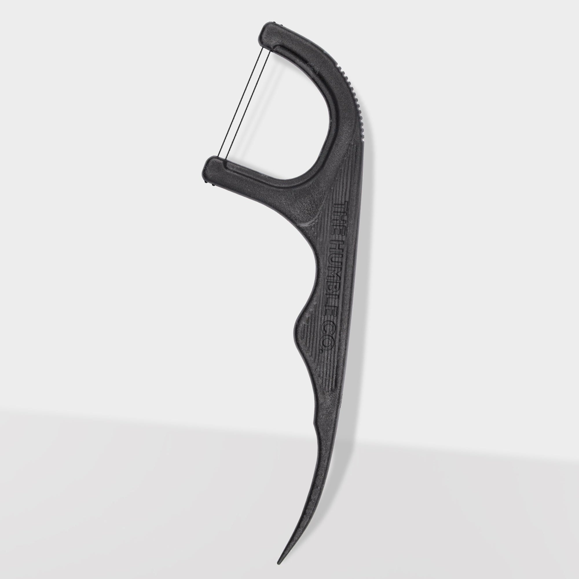 Black dental floss holder on a white background