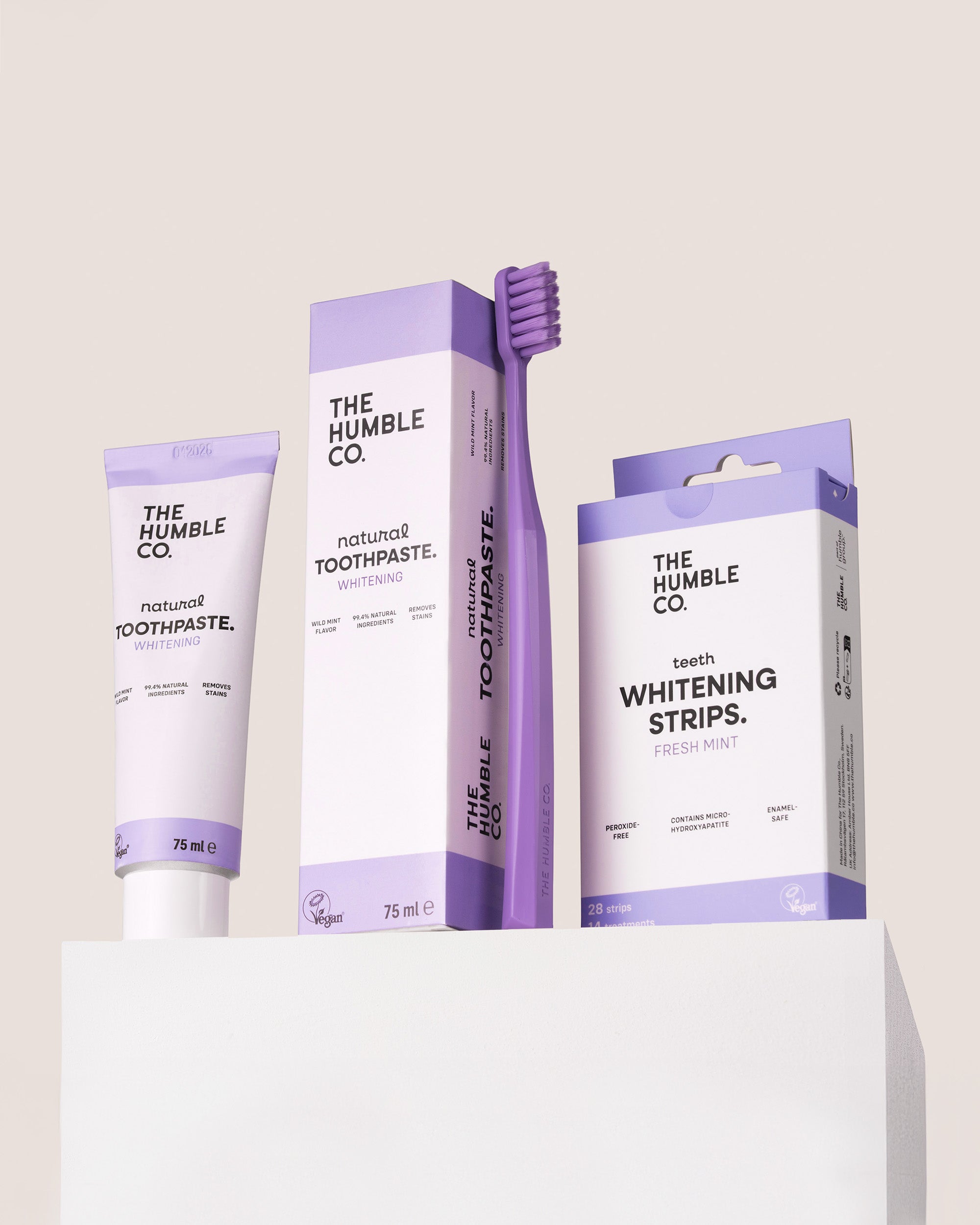 The Humble Co. dental care products including toothpaste, toothbrush, and whitening strips on a light background.