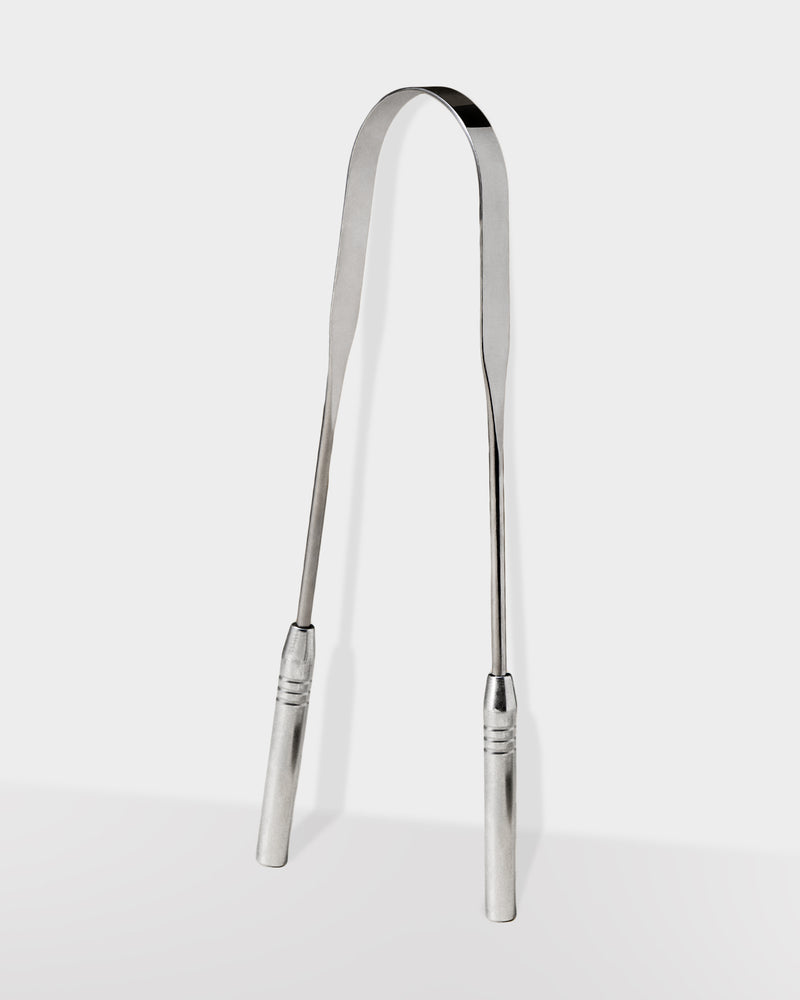 A silver stainless steel tongue scraper with a curved shape and ribbed handle.
