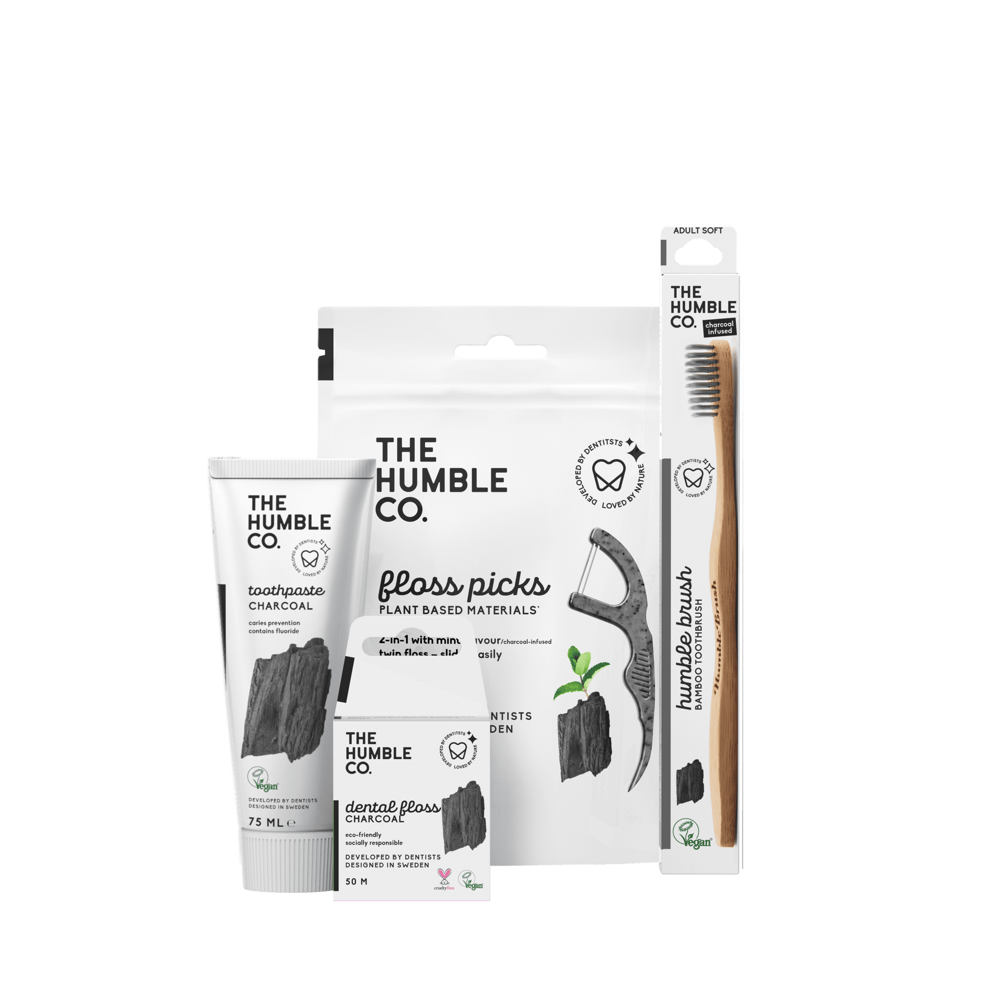 A sustainable oral care set from The Humble Co., featuring charcoal toothpaste, bamboo toothbrush, and floss picks, promoting eco-friendly and effective oral hygiene.