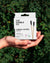 A person holds a box of The Humble Co. Bamboo Cotton Swabs, a sustainable option for reducing plastic waste.
