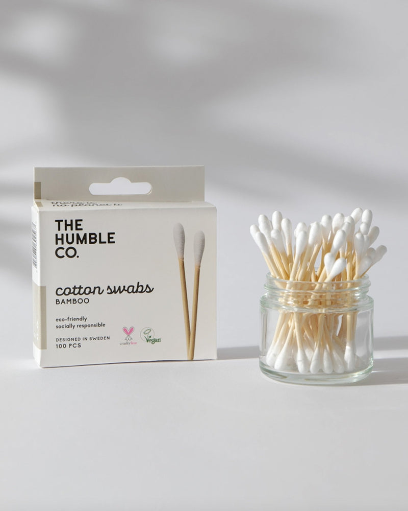 A box of The Humble Co. Cotton Swabs next to a jar containing white cotton swabs, showcasing a sustainable and eco-friendly alternative to disposable cotton swabs.